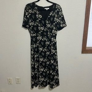 Fully lined, below knee length, black, off-white, and green floral.